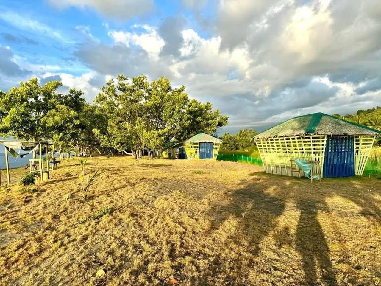 Open cottages on the shore in the late afternoon light